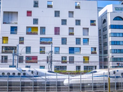 投稿：お洒落な建物の前ですれ違う白い新幹線